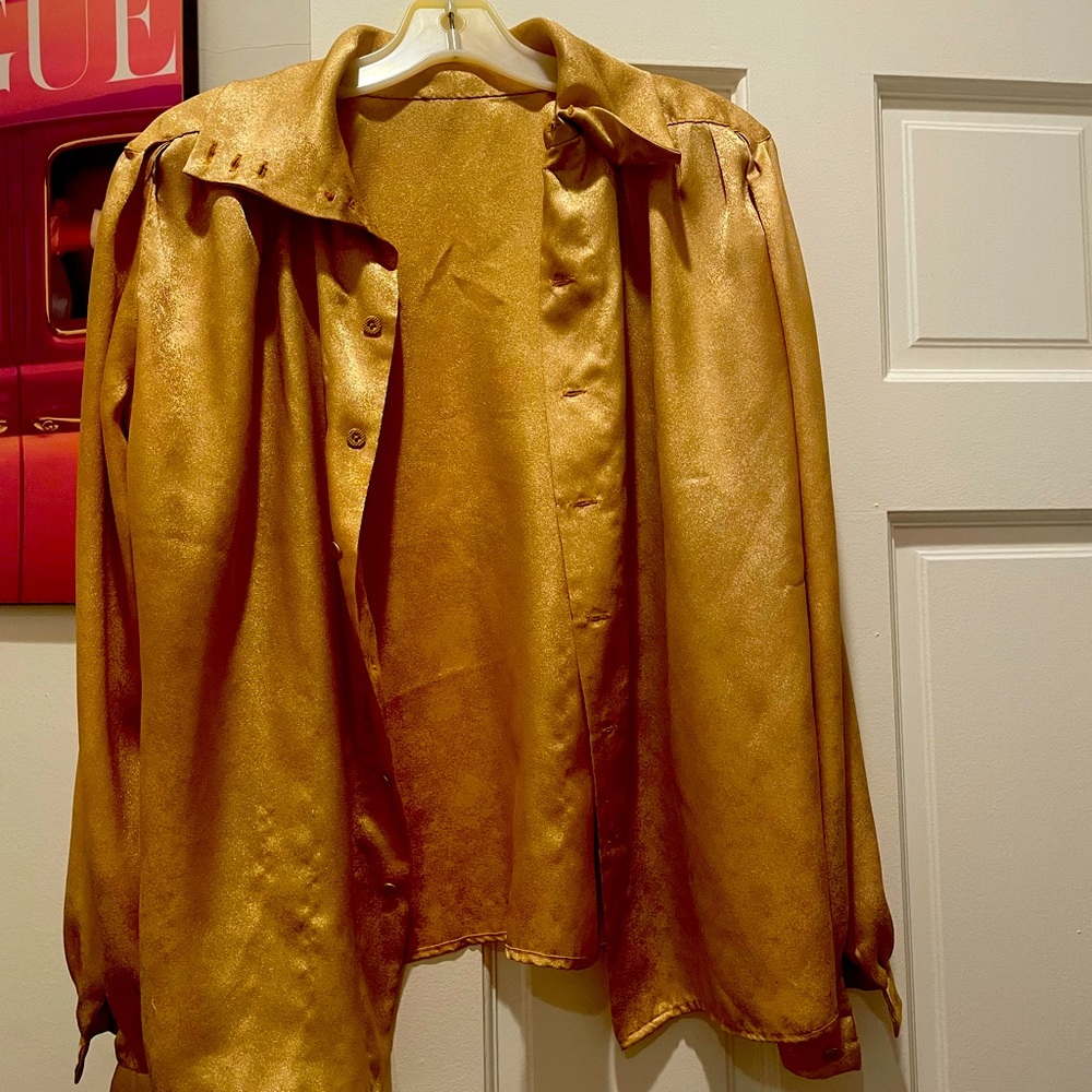 This is a gold vintage blouse in a size Medium